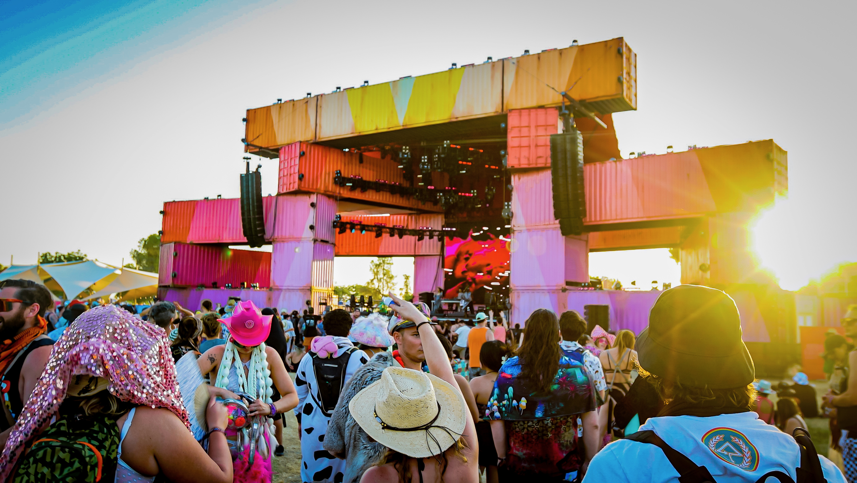 Festival main stage and crowd at golden hour